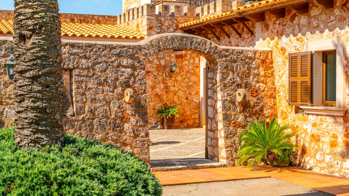 Runder Pool der Finca mit Sonnenliegen und Natursteinterrasse